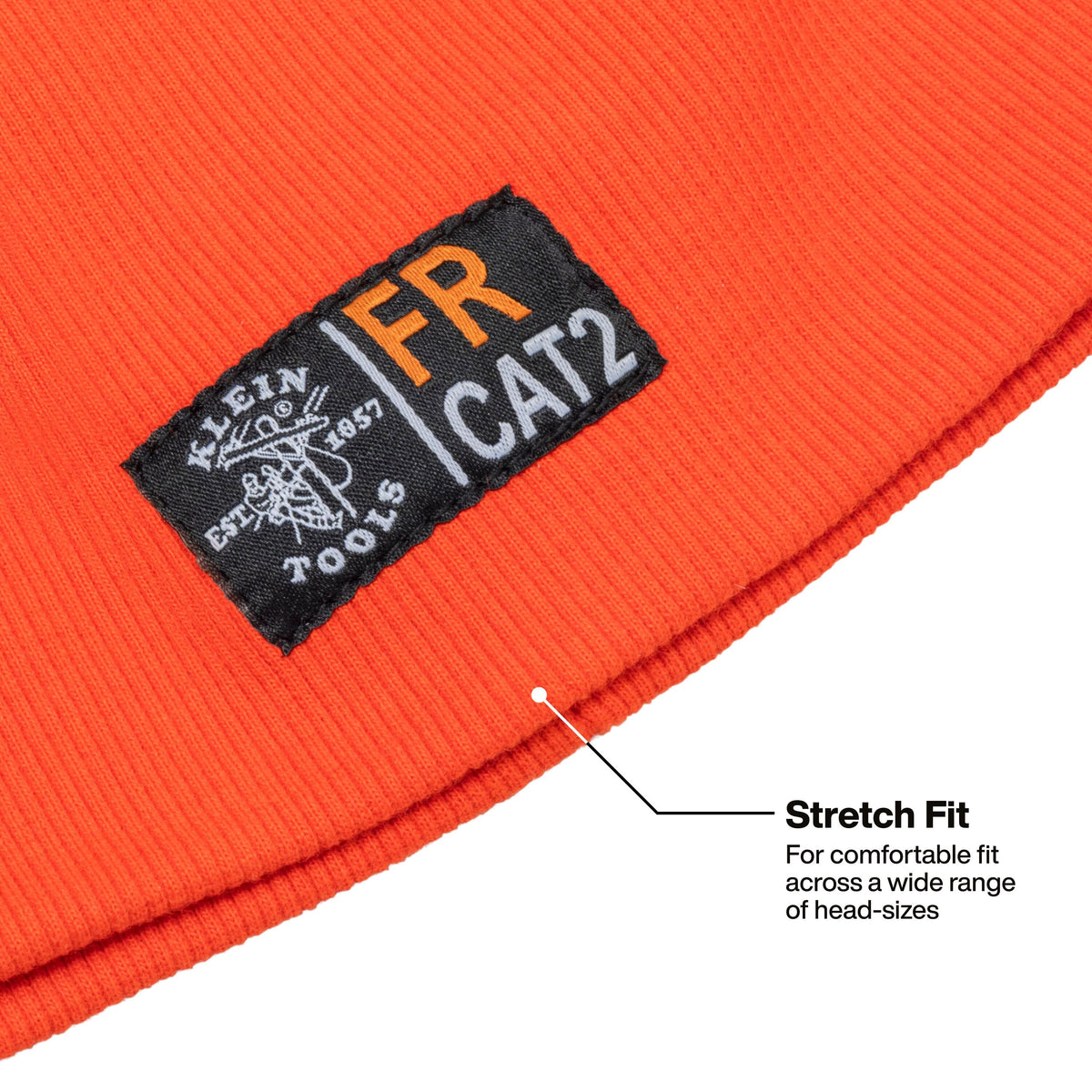Close-up of a bright orange ribbed knit beanie with a black sewn-in patch reading Klein Cat 2, plus a callout line and text noting stretch fit across a wide range of head sizes.