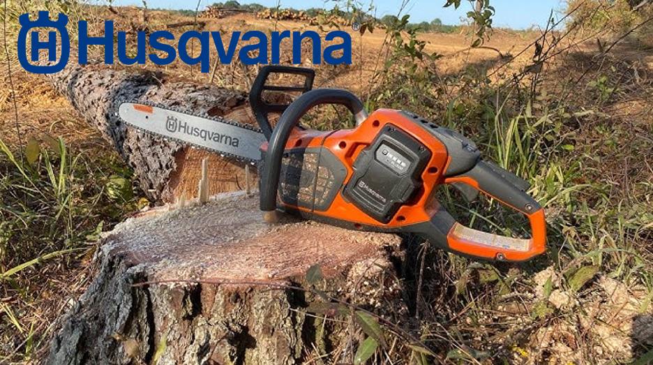 Husqvarna chainsaw cutting a log with the brand logo displayed.