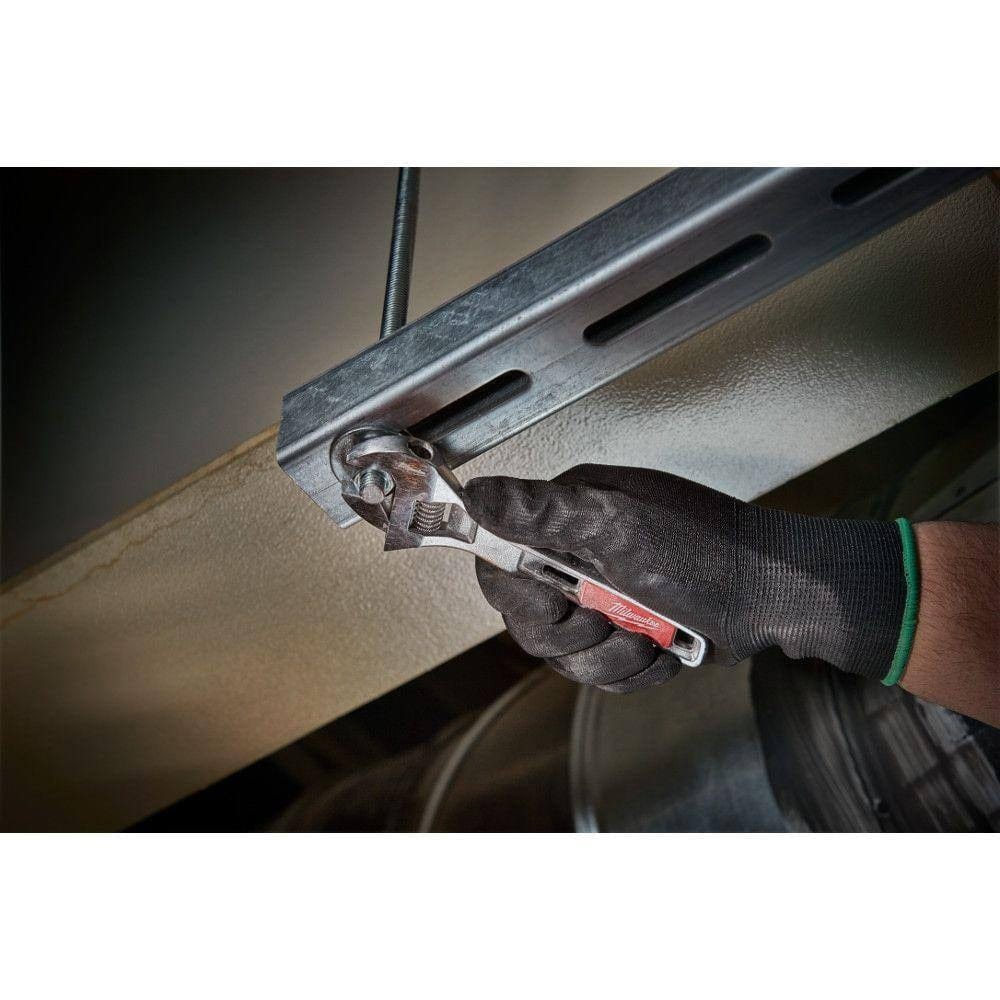 Action shot of a user wearing black gloves using the adjustable wrench to tighten a nut and bolt on a metal strut channel.