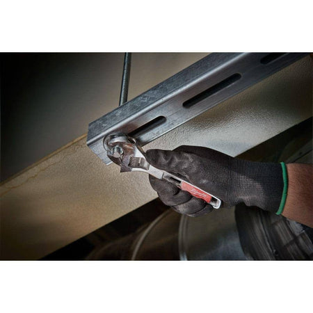 Action shot of a user wearing black gloves using the adjustable wrench to tighten a nut and bolt on a metal strut channel.