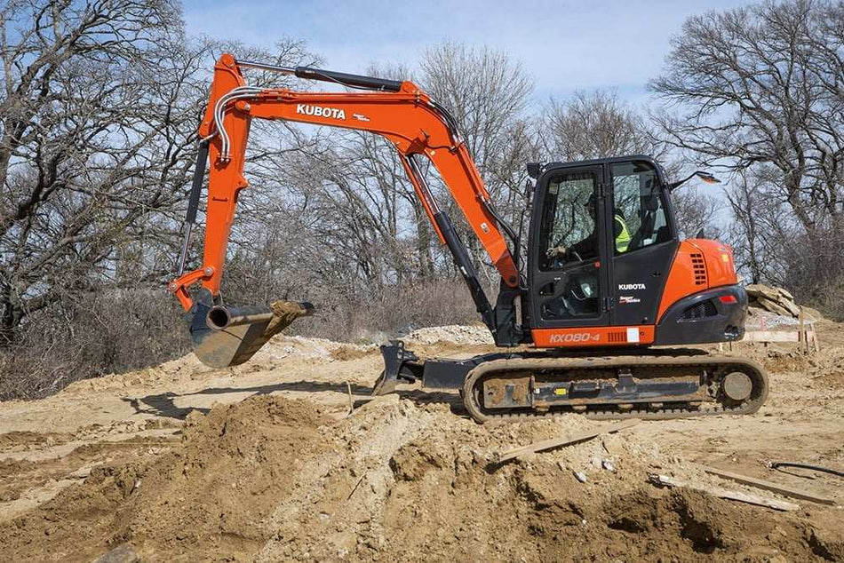 Kubota KX080-4 Power Utility Excavator resting on a large mound of dirt.
