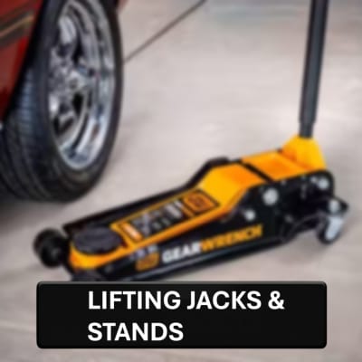 GearWrench lifting jack on a floor with a car wheel in the background