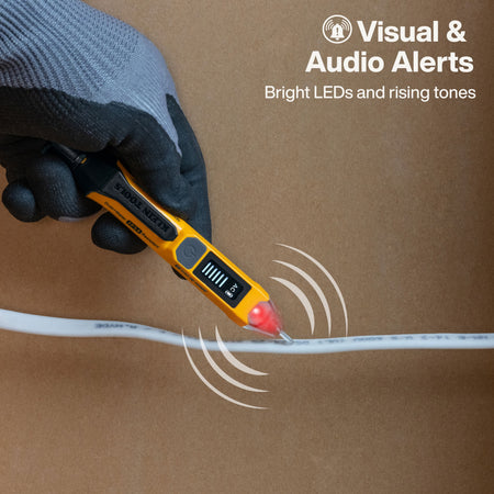 A gloved hand holds a yellow and black Fluke multimeter tester over a white cable, with graphic wave lines indicating visual and audio alerts. The background is a solid brown surface, and text in the upper right reads 'Visual & Audio Alerts'.