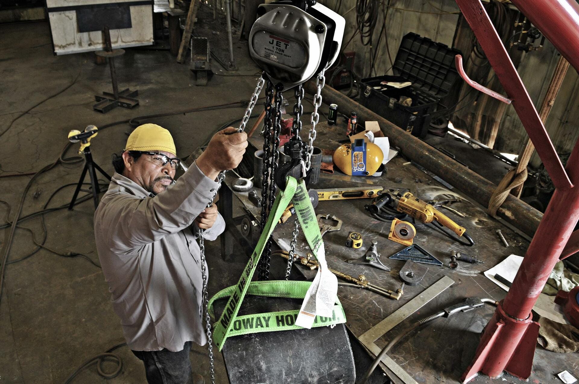 JET 2-Ton Hand Chain Hoist, 30' Lift (Model S90-200-30) used by worker in industrial workshop setting.