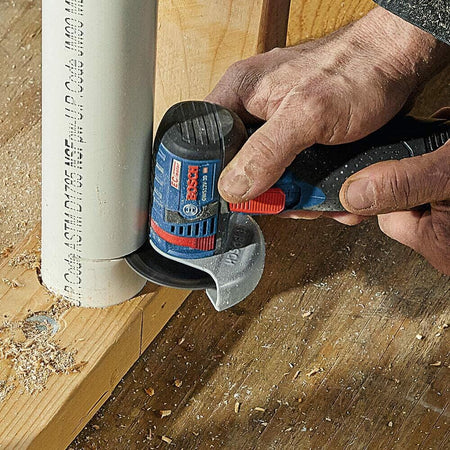 BOSCH DB343C 3 in. Continuous Rim Diamond Blade cutting PVC pipe on wood with Bosch rotary tool.