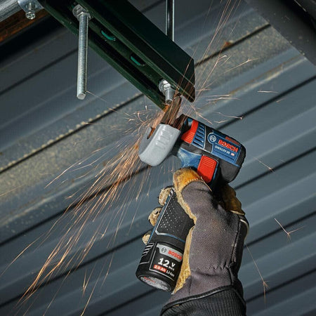 BOSCH DB343C 3 in. diamond blade cutting metal with sparks using a cordless grinder and gloves.