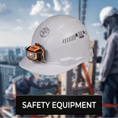 Klein Tools Safety equipment button with a hard had in the forefront and a couple of people working on a building in the background