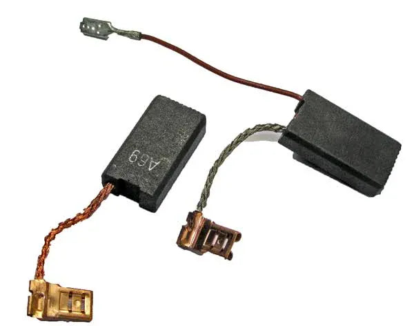 Two black rectangular carbon motor brushes with attached wires and metal contact points on a plain white background.