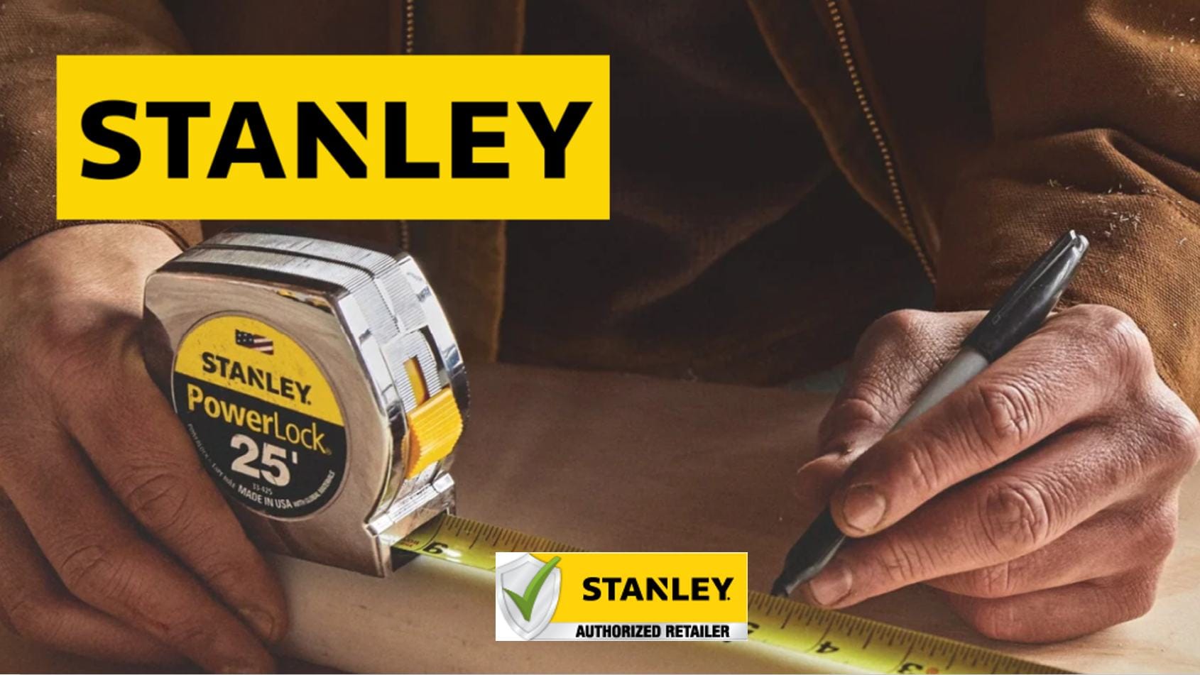 Person using a Stanley tape measure with a focus on the brand.