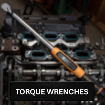 Torque wrench with a blurry engine in the background