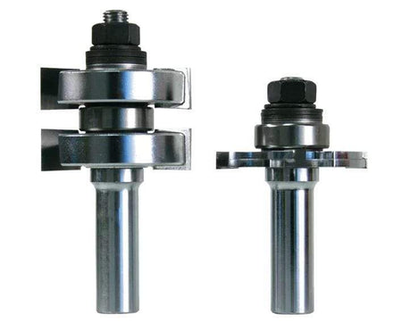 Image of tongue and groove bit set. The image shows two silver router bits with multiple cutting edges and black components near the top. The bit on the left appears to have adjustable parts with wing-like extensions.