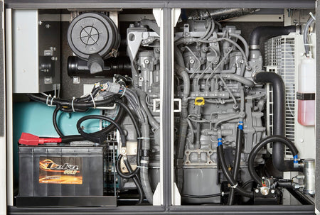 Open compartment of the generator, you feel a densely packed space filled with various mechanical and electrical components. There are thick, flexible hoses with ridges, a large cylindrical air filter, and a substantial rectangular battery with raised terminals and thick cables attached. You can also trace numerous wires and smaller tubes connecting to a complex, solid structure with various bumps and curves – this is the engine. You might also feel a container holding liquid and a large, finned panel, like