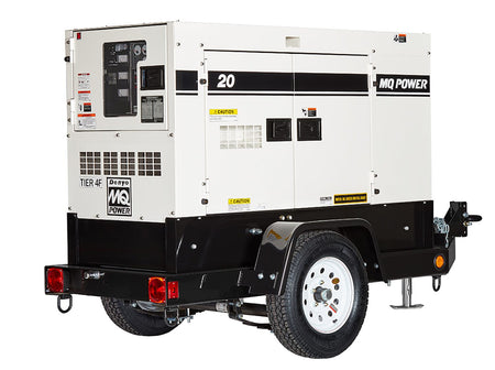  A large, boxy metal structure on wheels, like a small trailer. One end has a panel with various switches and outlets you could feel, suggesting it's a control area. The sides have smooth panels with some markings and vents. This is a portable power generator, designed to be towed to different locations to provide electricity.