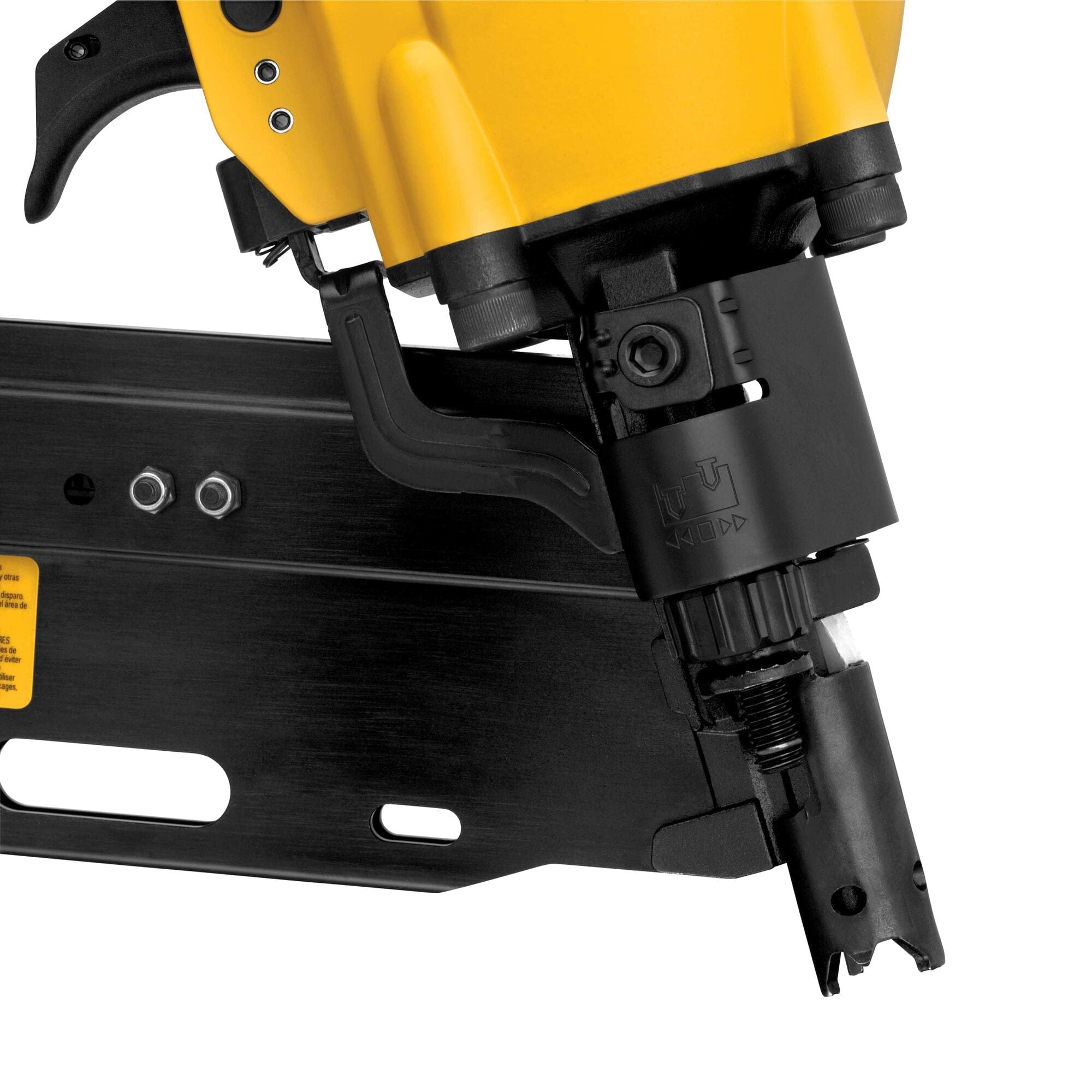 Close Up of Framing Nailer. The image shows a close-up of the black and yellow firing mechanism and nail magazine of a Dewalt framing nailer. The black magazine is partially visible, showing openings for nails, and the yellow body of the nailer features a black trigger and various mechanical components.
