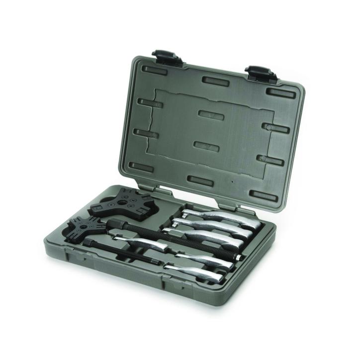 GearWrench 2 & 5 Ton 2 or 3 Jaw Internal/External Ratcheting Puller Set in hard case. The image shows a gray plastic carrying case for a tool set, propped open to reveal its contents. Inside, several silver-colored and black metal tools are neatly organized in molded compartments, including several pullers and adapters for mechanical work