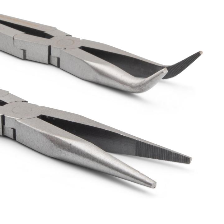 The pliers are positioned one above the other, with the jaws pointing towards the right side of the image. The jaws are silver-colored metal and are in sharp focus, highlighting the different tip designs. The top pair has curved, angled tips, while the bottom pair has pointed, needle-nose tips. The rest of the pliers are slightly out of focus, emphasizing the detail of the jaws.