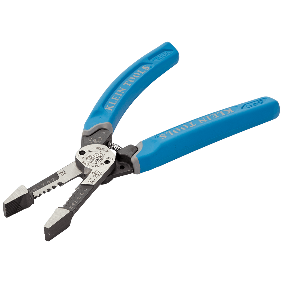 Image of Klein-Kurve® Heavy-Duty Wire Stripper 8-20 AWG K12035. This is an angled, close-up shot of a pair of open wire strippers against a dark background with a subtle grid pattern. The strippers have bright blue handles with the brand name "KLEIN TOOLS" printed on them, and the silver cutting blades are positioned at the bottom left of the image.