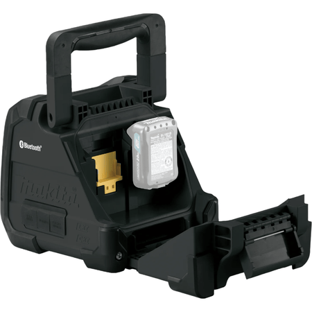 The back of a box-shaped device with a handle shows an open compartment. Inside, there is a space for a battery with a yellow connector.