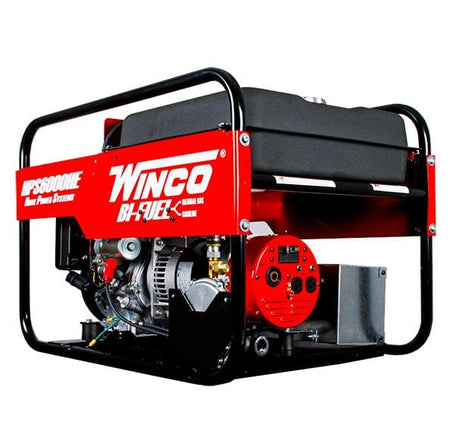  Winco HPS6000HE Bi-Fuel Generator. You can see the red side panel prominently displaying the "WINCO" logo and the "HPS6000HE Home Power Systems" model name. The "BI-FUEL" marking is also visible, indicating its ability to run on either natural gas or gasoline. The black fuel tank is situated on top, and the sturdy black roll cage frame surrounds the entire unit. You can also see parts of the engine and the red electrical outlet panel on the side.